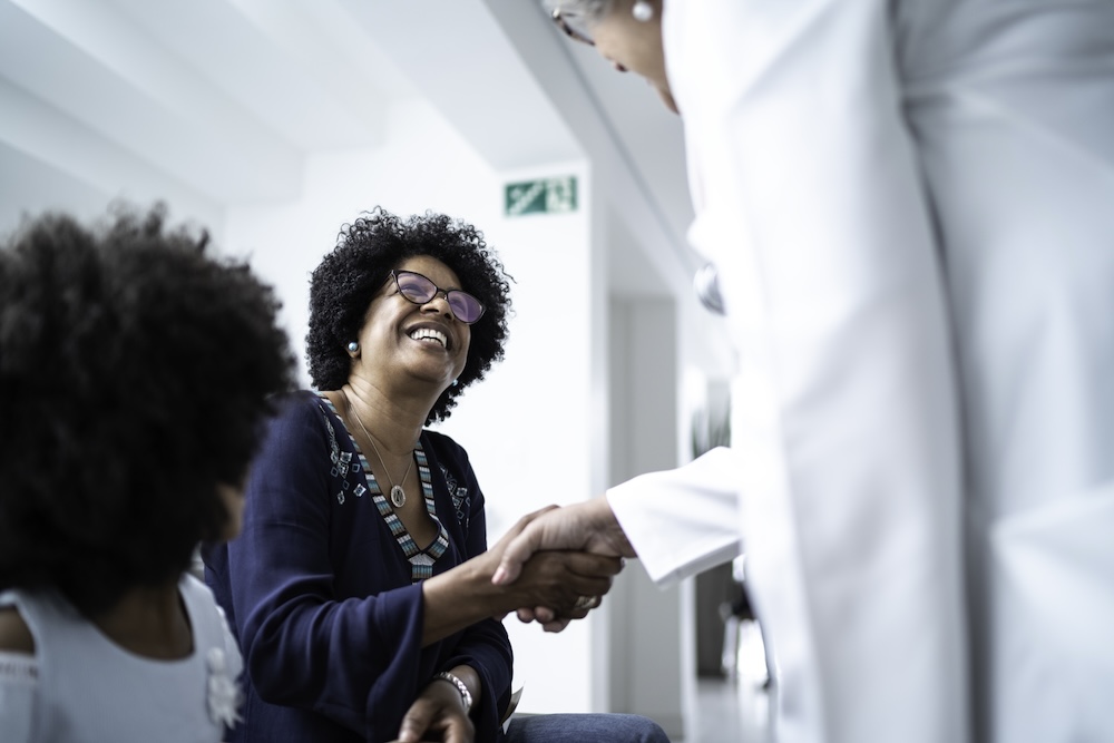 Woman shaking doctors hand